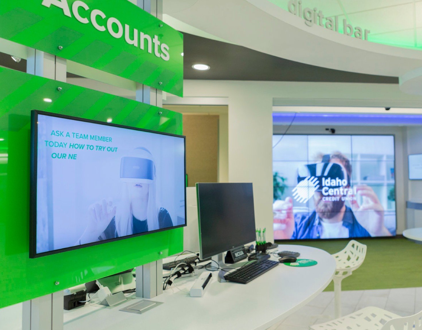 A desk with a monitor and computer showing accounts