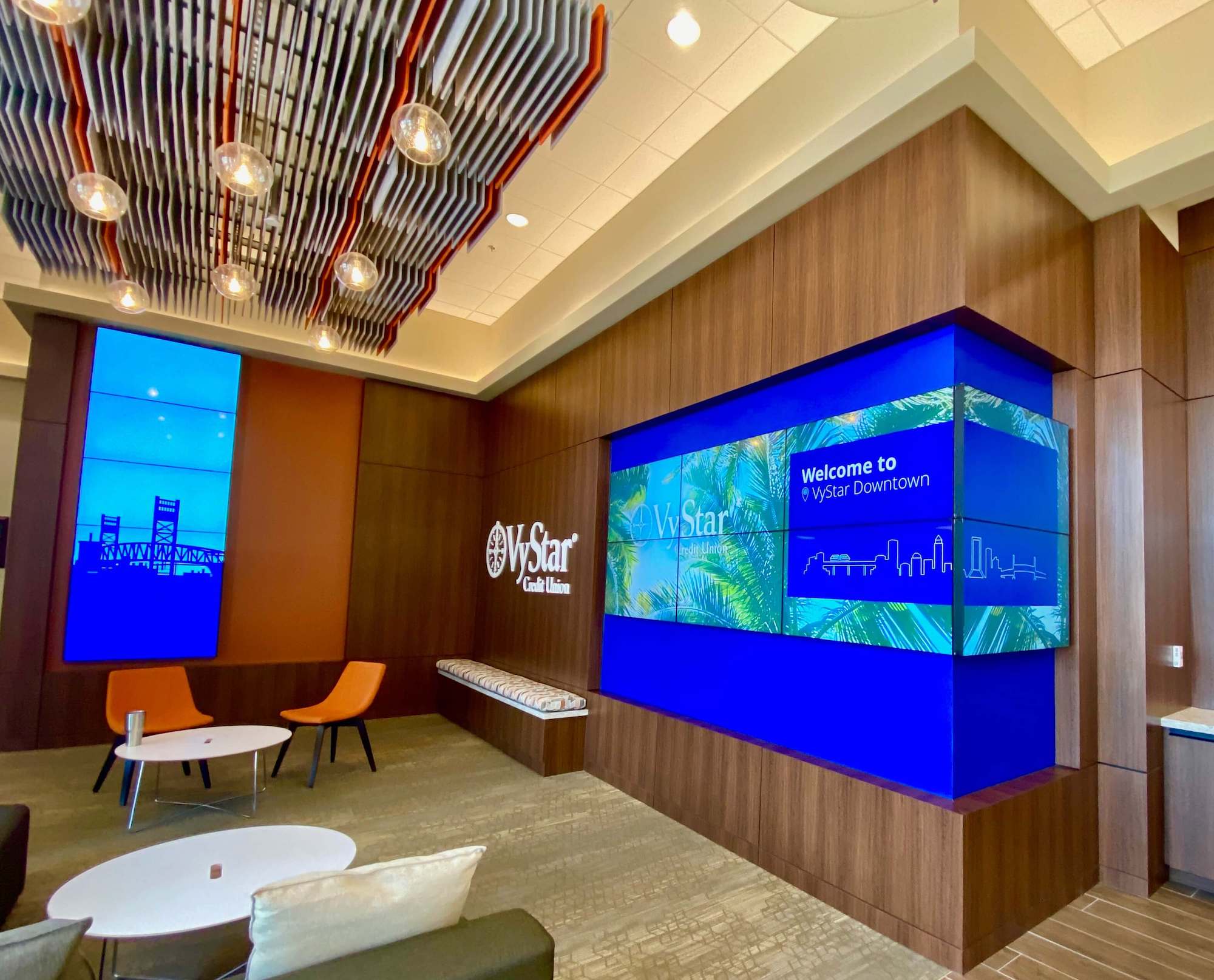 a lobby with tv's and screens on the walls