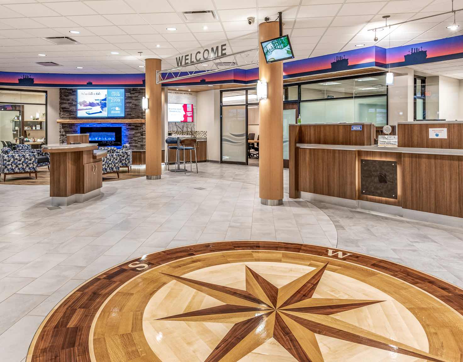 A grand bank lobby with a large wooden compass detail on the floor.