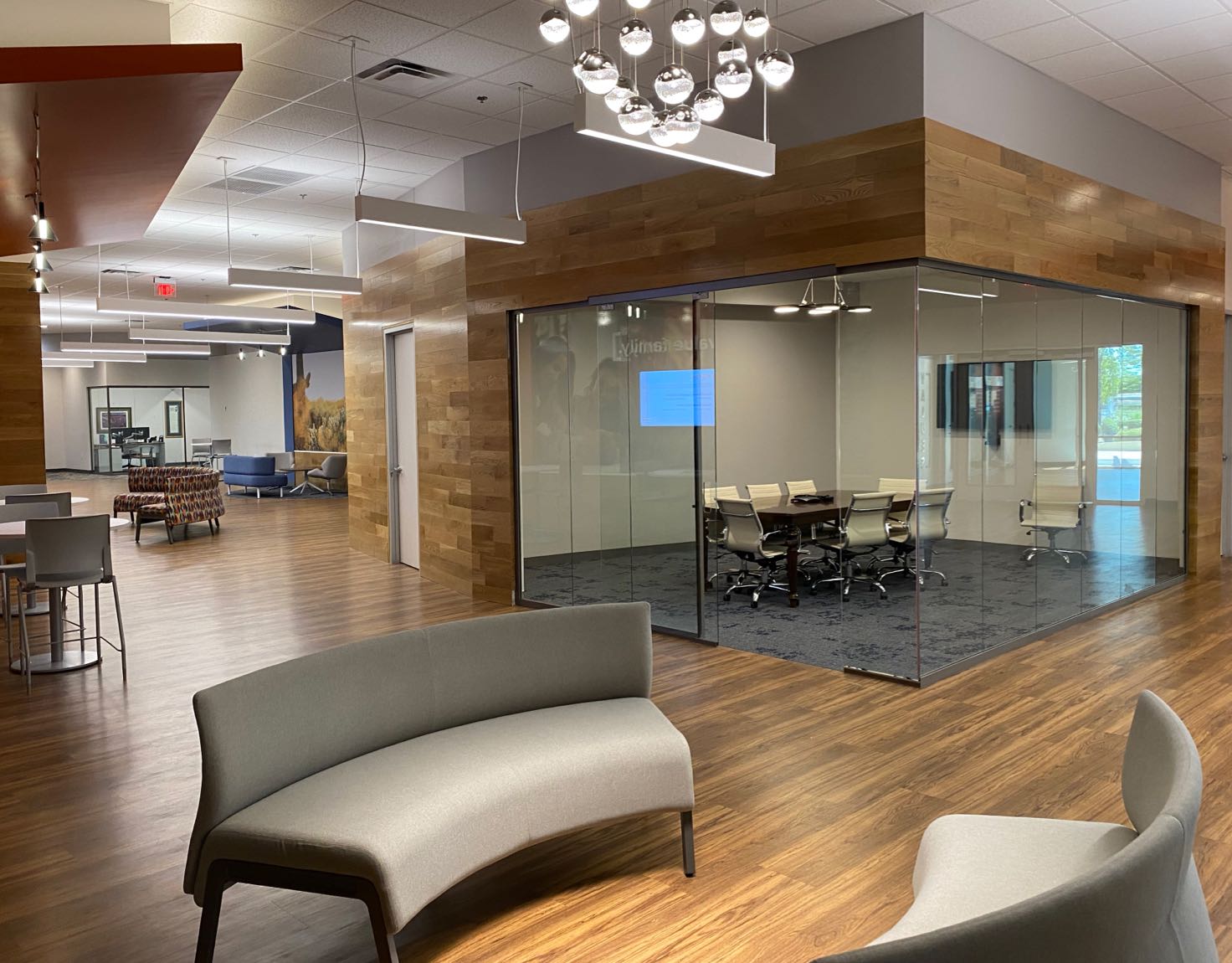 An office lobby with a glass conference room in the background.