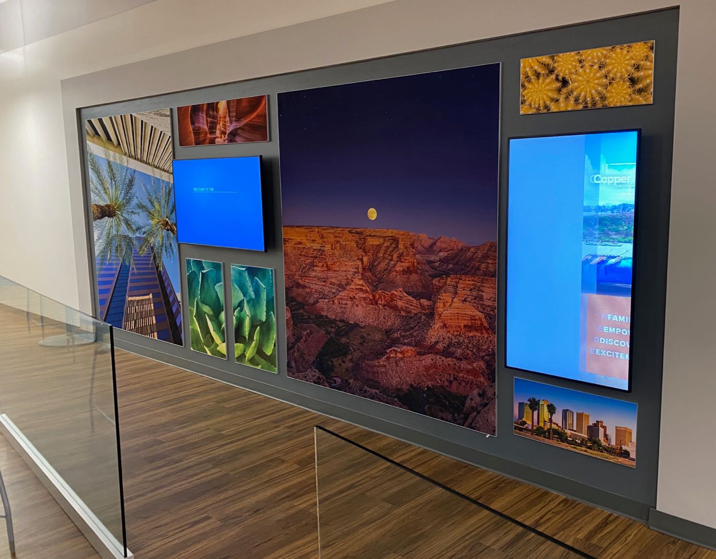 A wall of screens displaying different outdoor landscapes.