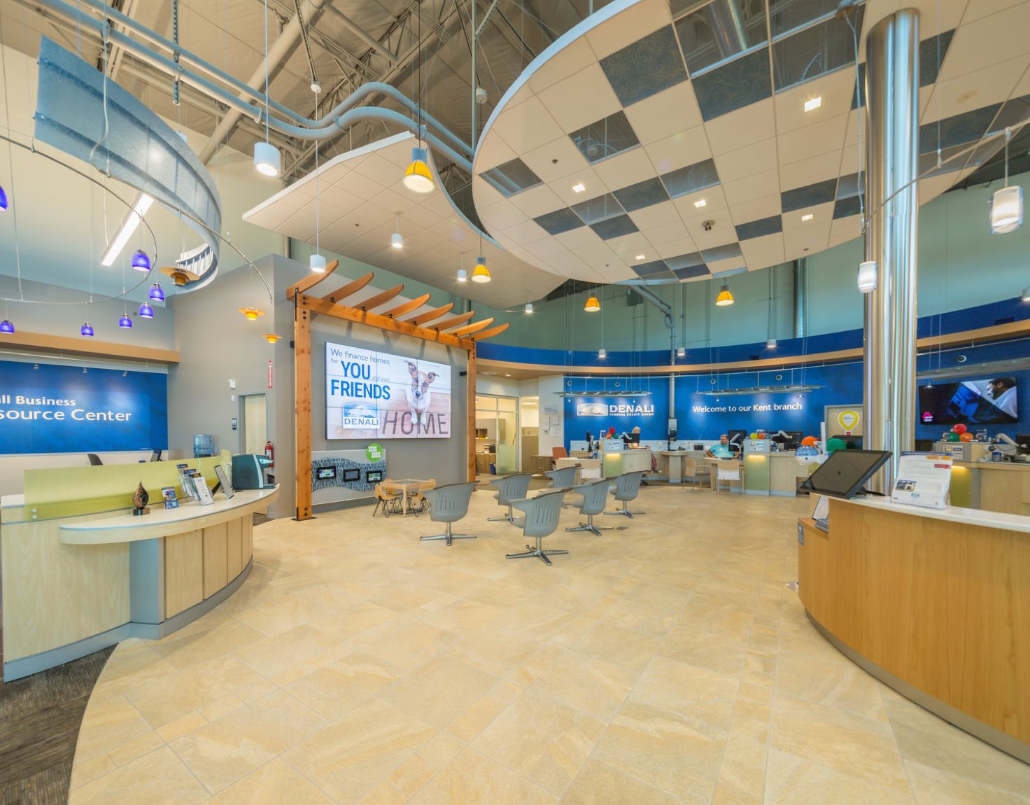 A large bank lobby with many chairs, desks, and screens.