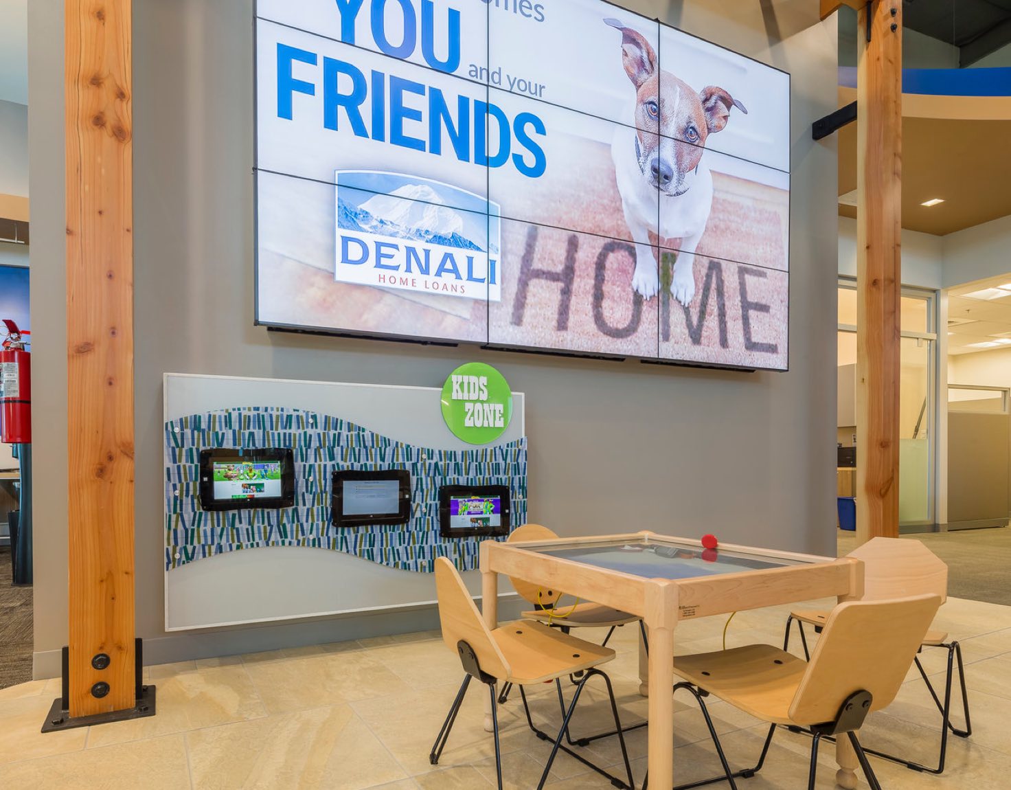 A children's waiting room with touchscreens in a bank lobby.