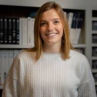 A woman in a white sweater.