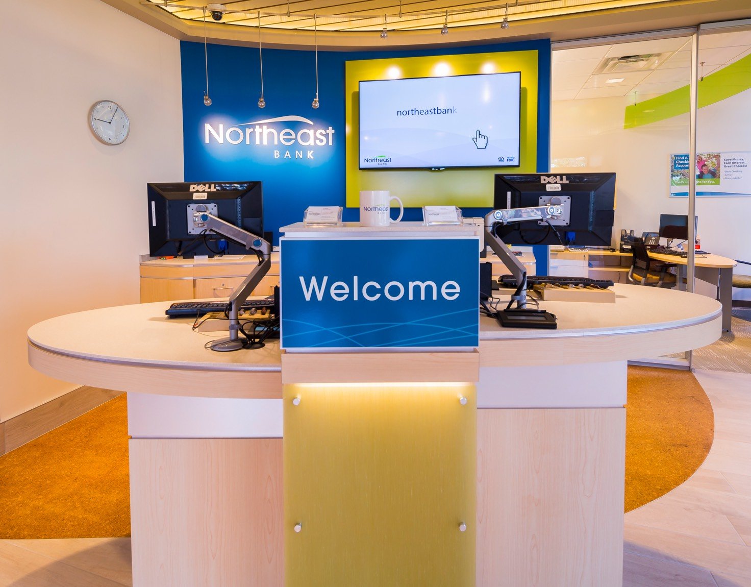 A bank teller desk with a blue Welcome sign.