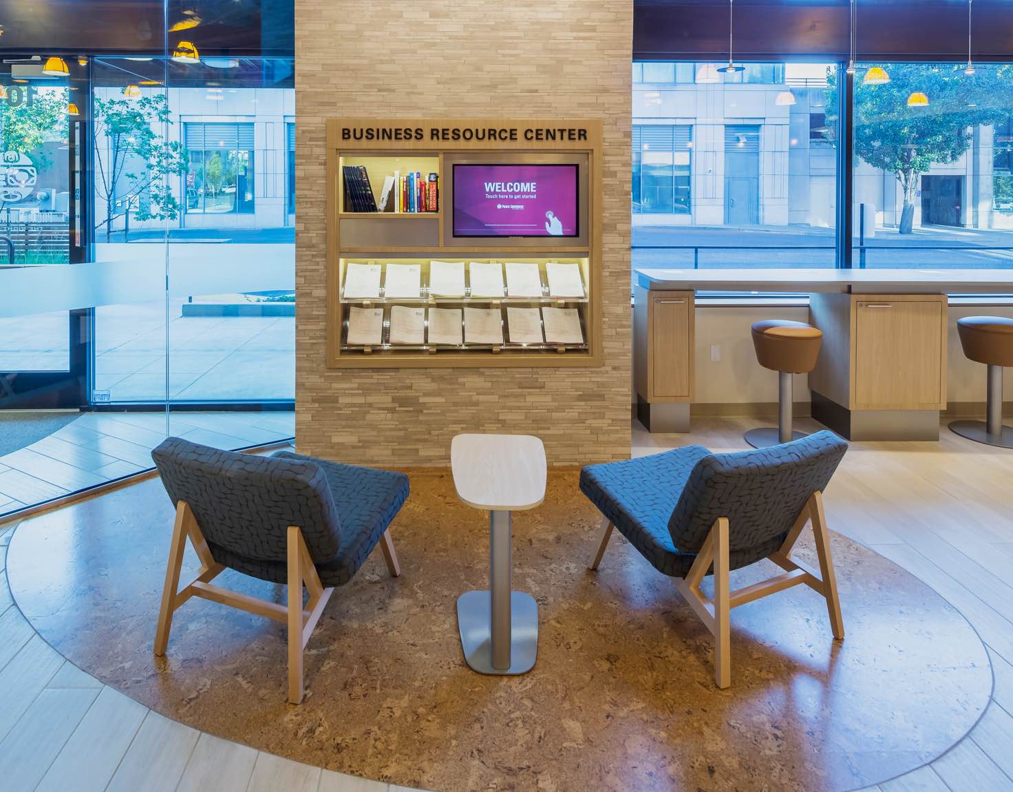 A business resource center waiting room with a wall of resources.