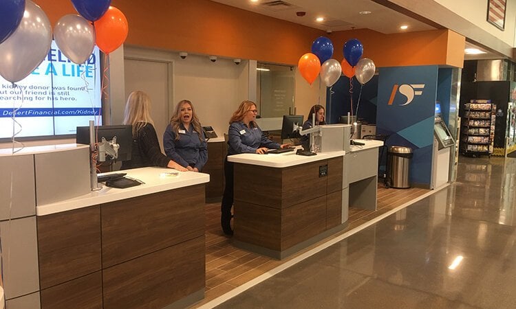 Women working behind desks in a bank.