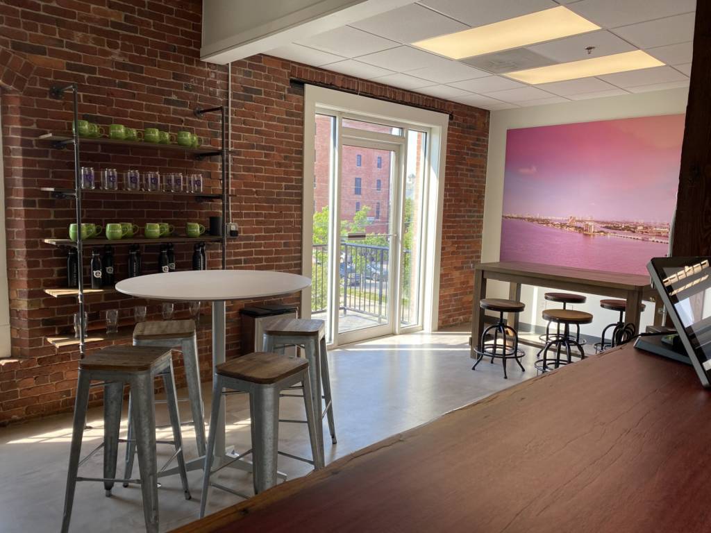 A small dining area with two tables and a few chairs.