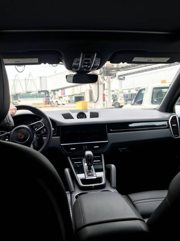 Inside a car, pulling up to an airport.