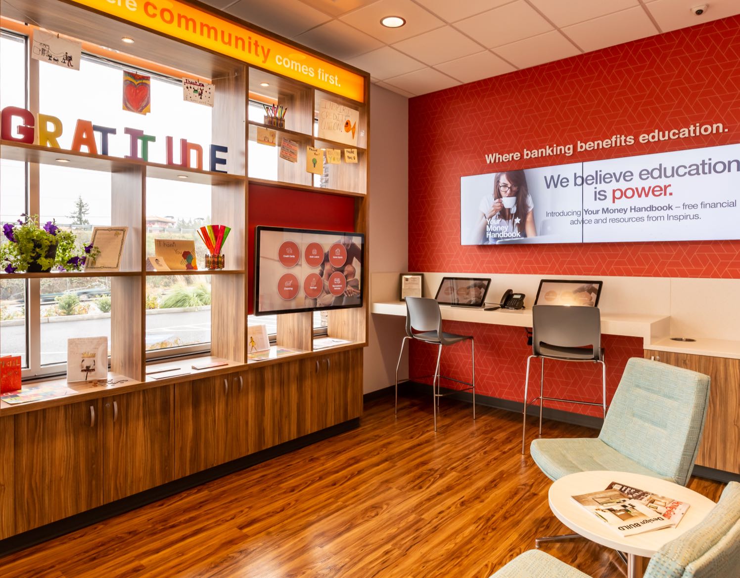 A waiting area with leather chairs and shelves in front of a window.