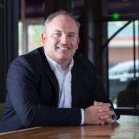 A man sitting in a suit.