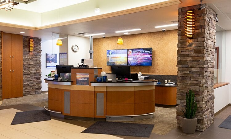 A bank lobby with a curved front desk.