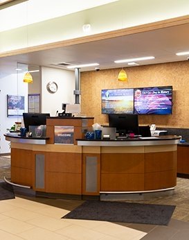 A curved desk in the front of a desk lobby.