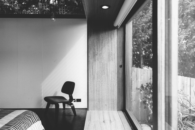 A black and white photo of a bedroom window.