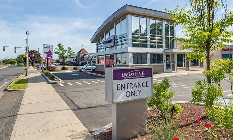 An sign at the entrance to a bank parking lot.