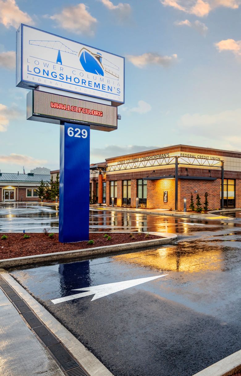 A large sign in the parking lot of a bank.