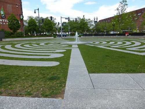A courtyard with a walkway maze, and a fountain in the middle.