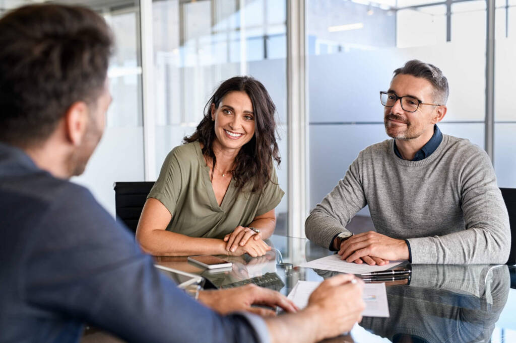 couple sitting across from a consultant at a table