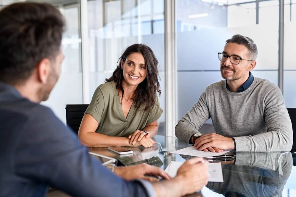 couple sitting across from a consultant at a table.