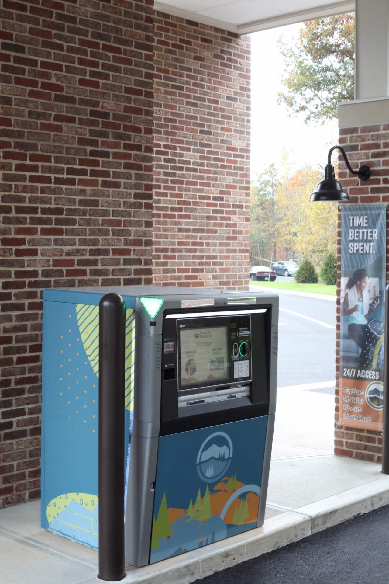 Close-up of an interactive teller machine at Granite State Credit Union with a digital screen and promotional signage.