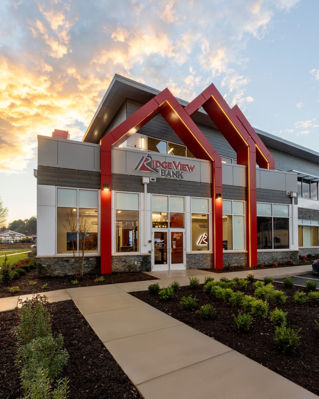 image of the outside of a ridgeview bank building with large red pointed architectural details around the main doorway
